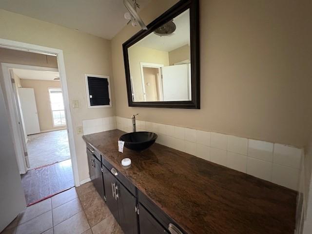 bathroom featuring tile patterned flooring, vanity, and baseboards