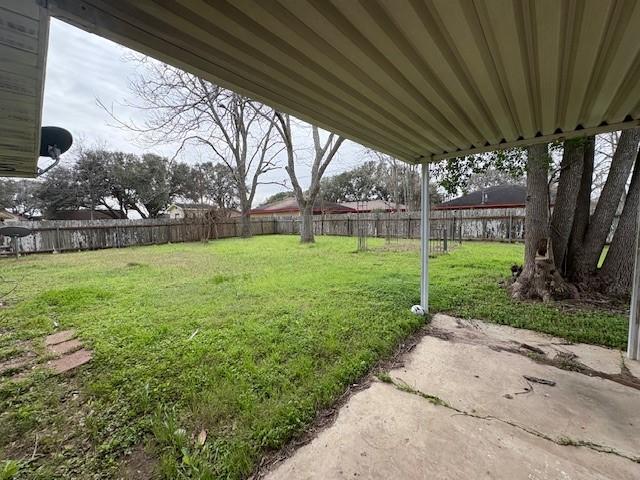 view of yard with a patio area and a fenced backyard