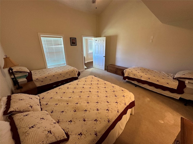 bedroom featuring high vaulted ceiling and carpet flooring