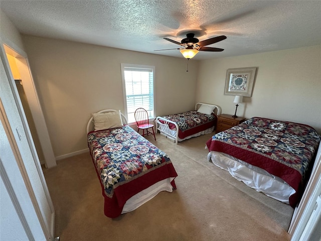 bedroom with ceiling fan, a textured ceiling, and carpet flooring