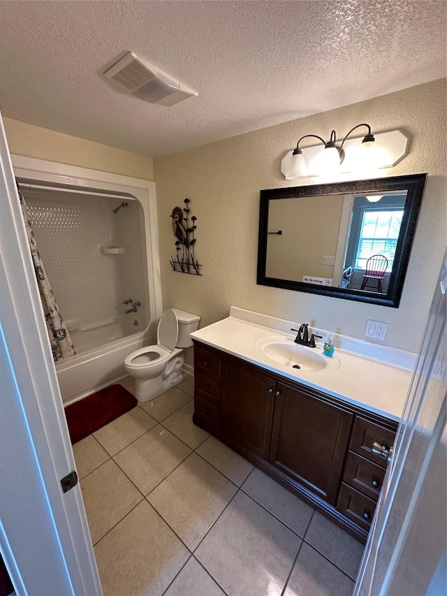 bathroom with visible vents, a textured wall, vanity, and a textured ceiling