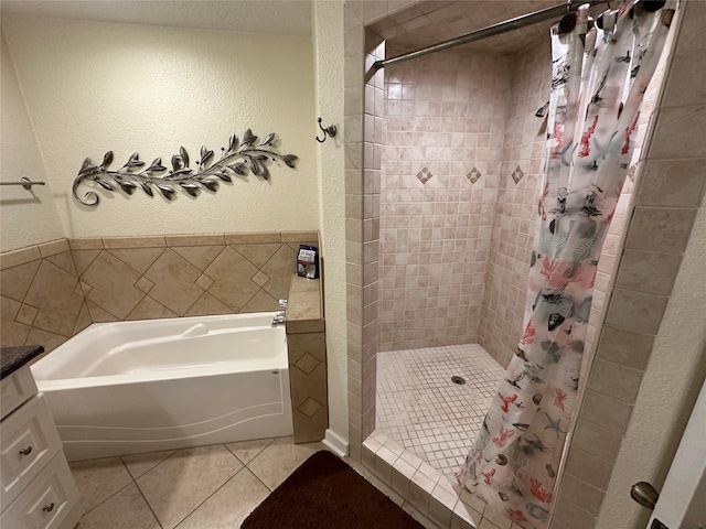 full bathroom featuring a textured wall, a stall shower, a garden tub, and tile patterned floors