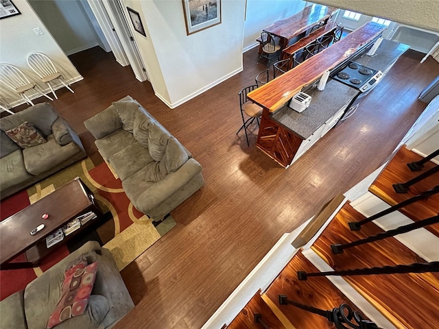 living area featuring baseboards and wood finished floors