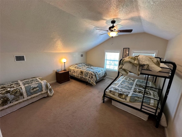 carpeted bedroom featuring baseboards, visible vents, a ceiling fan, vaulted ceiling, and a textured ceiling