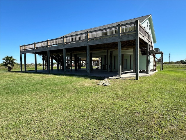 rear view of house with a deck and a lawn