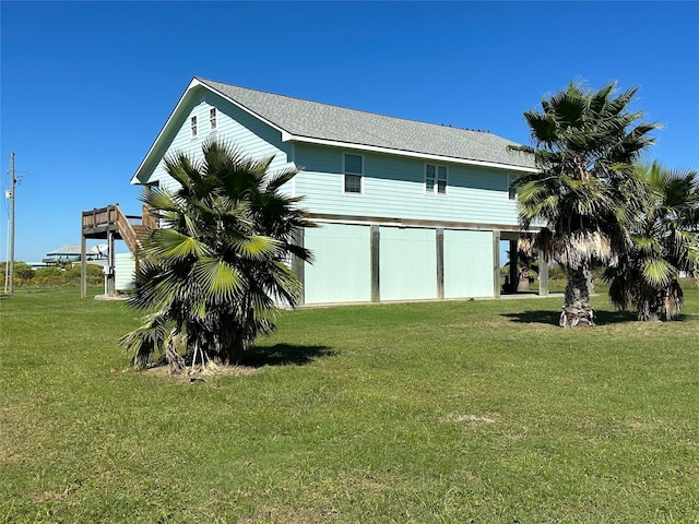 view of side of home with a yard