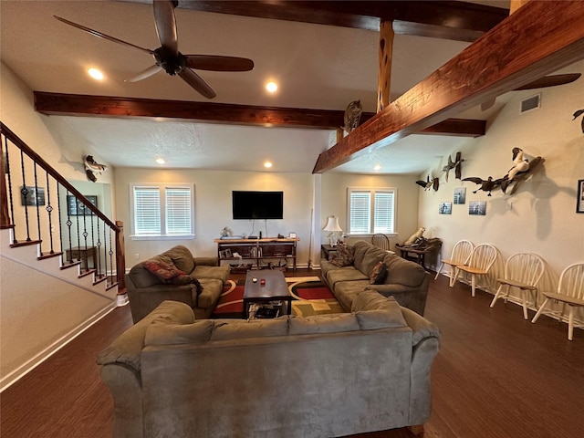 living room with visible vents, baseboards, stairs, dark wood-style floors, and beamed ceiling