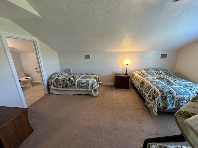 bedroom featuring carpet floors, visible vents, and a textured ceiling