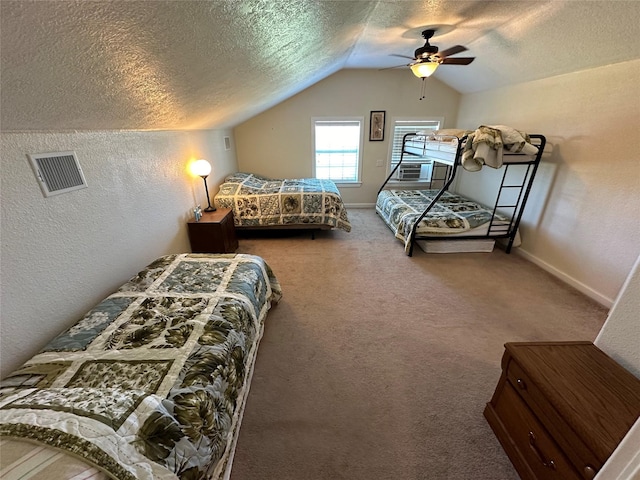 bedroom featuring a textured ceiling, a textured wall, carpet flooring, visible vents, and vaulted ceiling