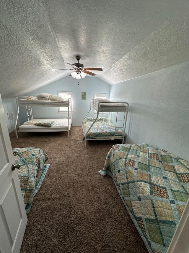 carpeted bedroom featuring lofted ceiling, ceiling fan, and a textured ceiling