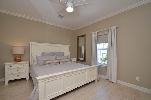 bedroom with baseboards, light wood-type flooring, visible vents, and crown molding