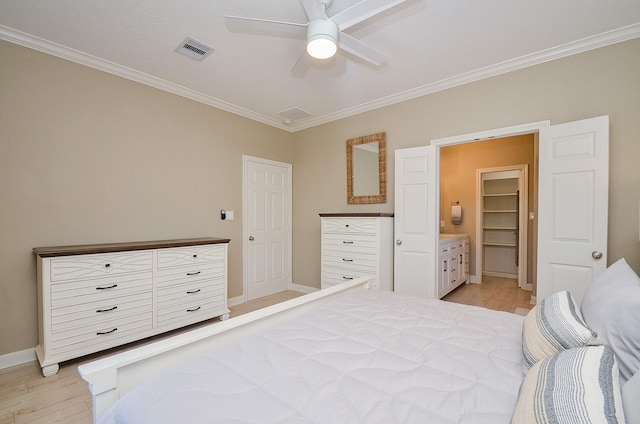 bedroom with baseboards, visible vents, connected bathroom, light wood-style flooring, and crown molding