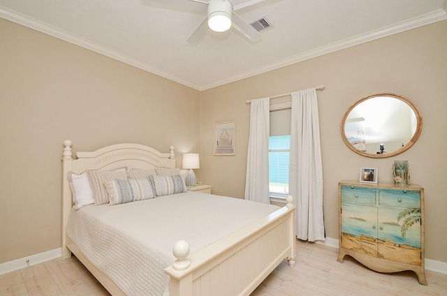 bedroom featuring ornamental molding, light wood finished floors, and visible vents