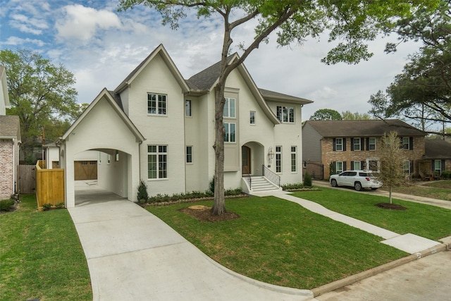 view of front of home featuring driveway, a front lawn, and fence