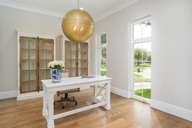 home office featuring ornamental molding, light wood-style flooring, and baseboards