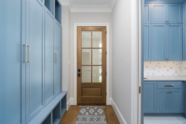 mudroom featuring baseboards, light wood-style flooring, and crown molding