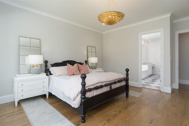 bedroom featuring crown molding, baseboards, and wood finished floors