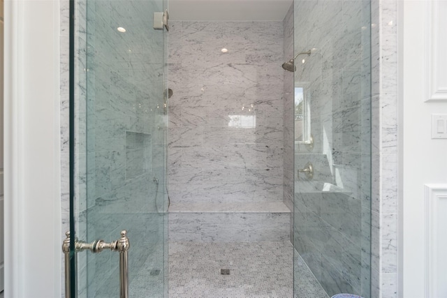 full bath with a marble finish shower