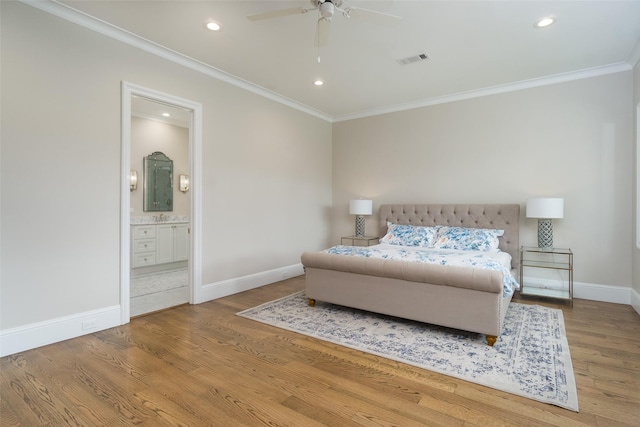 bedroom featuring baseboards, crown molding, visible vents, and wood finished floors