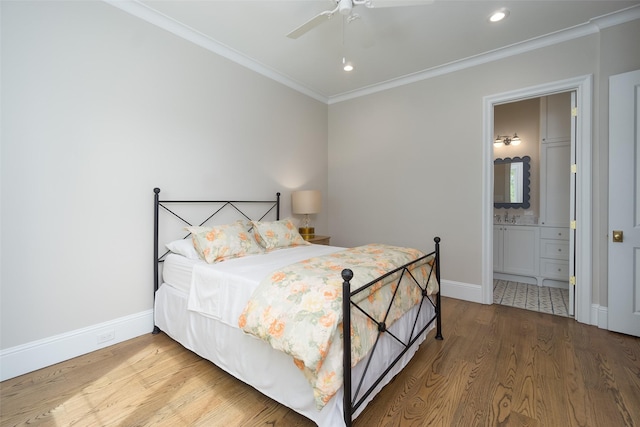 bedroom featuring baseboards, crown molding, and wood finished floors