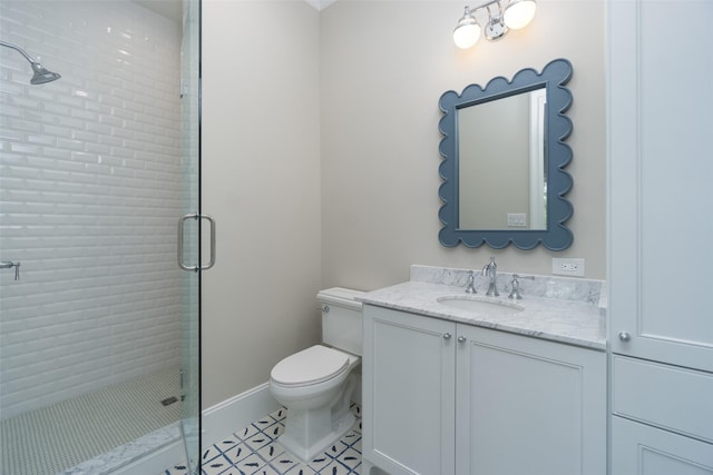 full bath with toilet, a shower stall, vanity, baseboards, and tile patterned floors