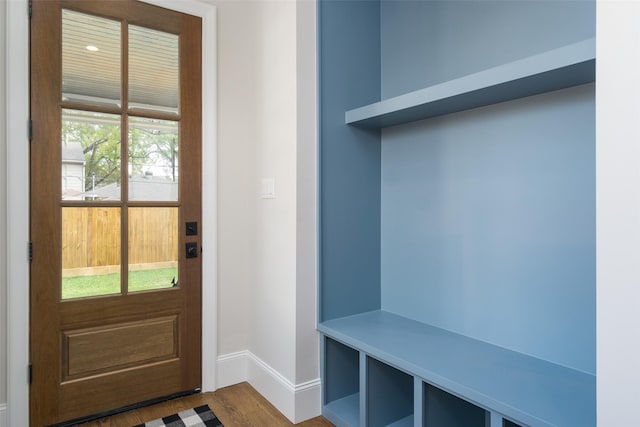 mudroom featuring dark wood finished floors and baseboards