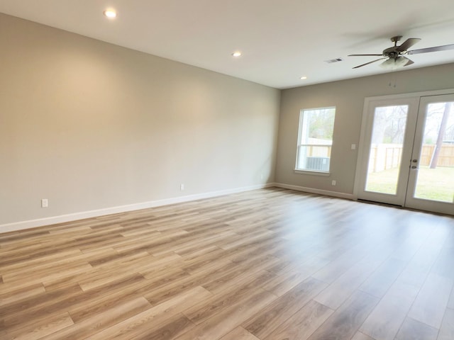 empty room with light wood-type flooring, visible vents, baseboards, and recessed lighting