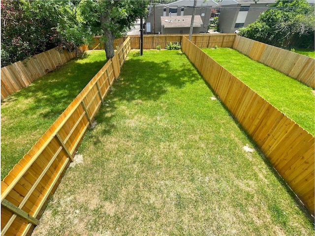 view of yard with a fenced backyard