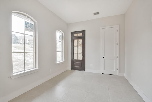 foyer with baseboards and light tile patterned floors