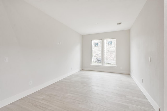 unfurnished room featuring light wood-style floors and baseboards