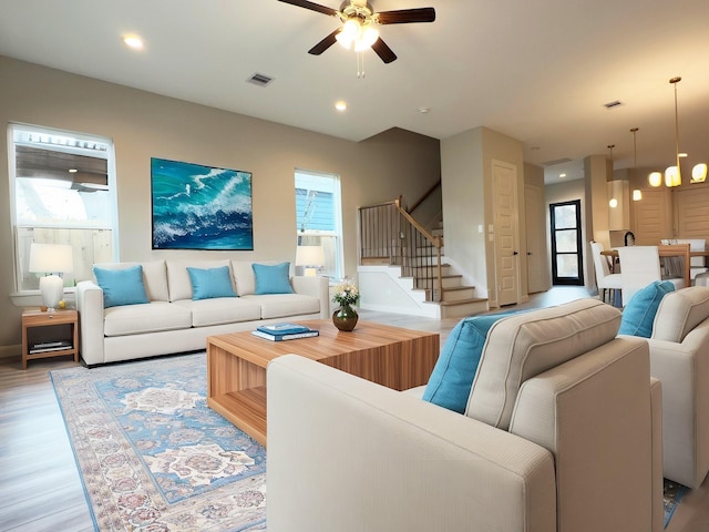 living room featuring recessed lighting, visible vents, ceiling fan, wood finished floors, and stairs