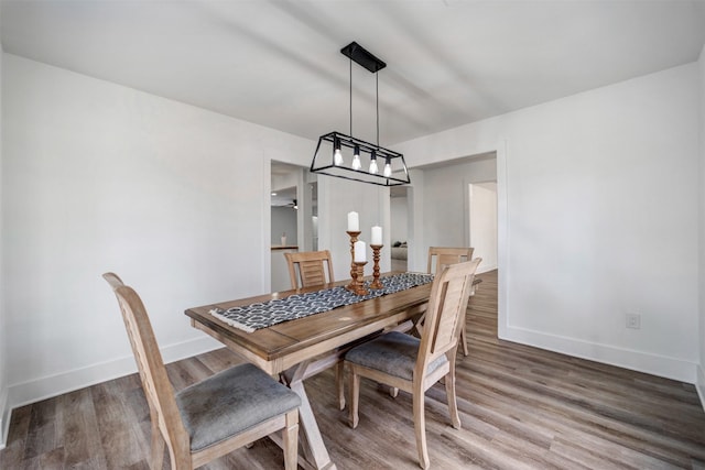 dining room with baseboards and wood finished floors