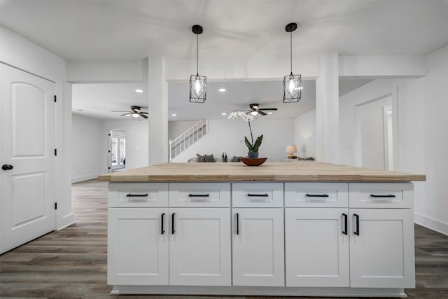 bar with recessed lighting, dark wood-type flooring, baseboards, stairway, and pendant lighting