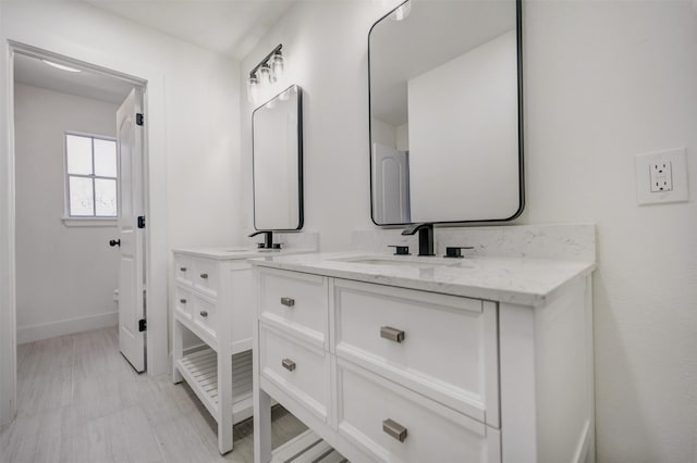 bathroom featuring baseboards and vanity