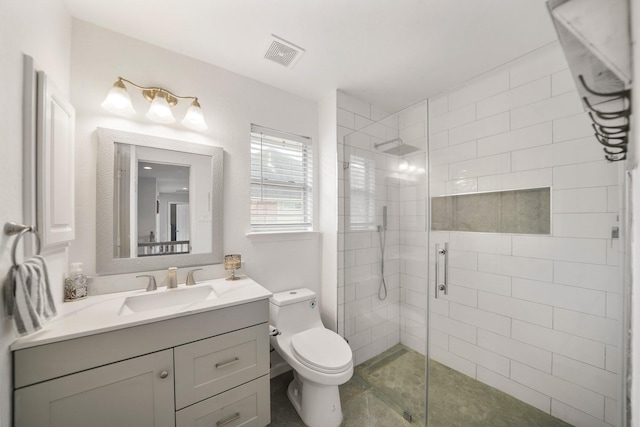 bathroom with a stall shower, visible vents, vanity, and toilet