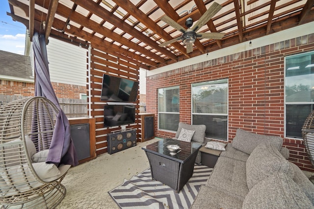 living room featuring brick wall and ceiling fan