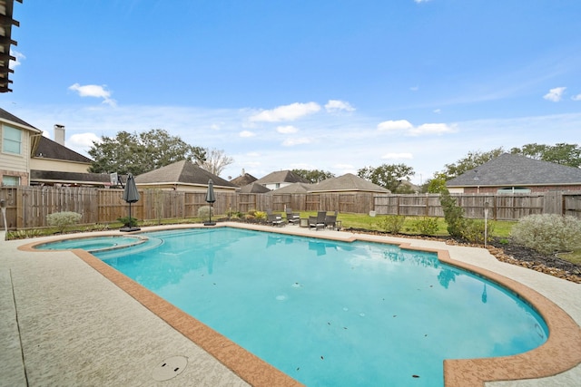 view of pool featuring a patio, a fenced backyard, and a pool with connected hot tub