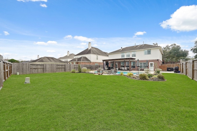 rear view of house featuring a yard, a fenced in pool, a fenced backyard, and a patio