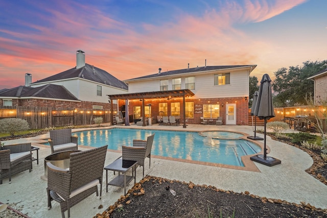 view of swimming pool with a patio area, fence private yard, and a pool with connected hot tub