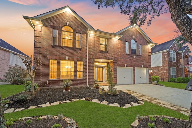 traditional-style house with concrete driveway, brick siding, and an attached garage