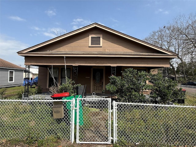 view of front of house with a porch, a gate, and a fenced front yard