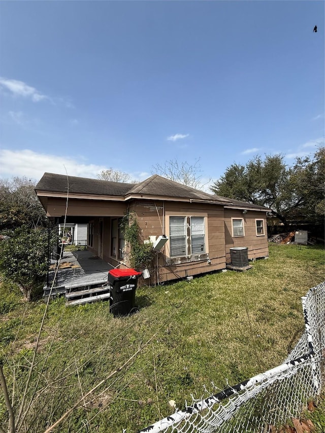 rear view of property with a yard