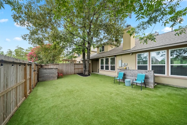 view of yard with a fenced backyard