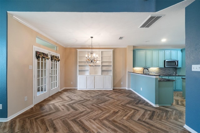 kitchen featuring a notable chandelier, visible vents, ornamental molding, french doors, and stainless steel microwave