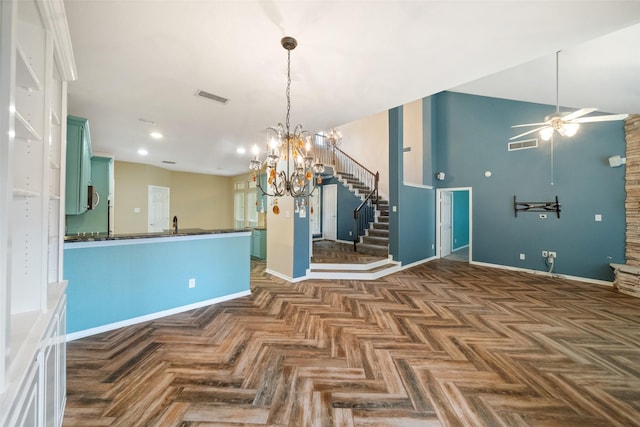 interior space with dark countertops, visible vents, baseboards, and ceiling fan with notable chandelier