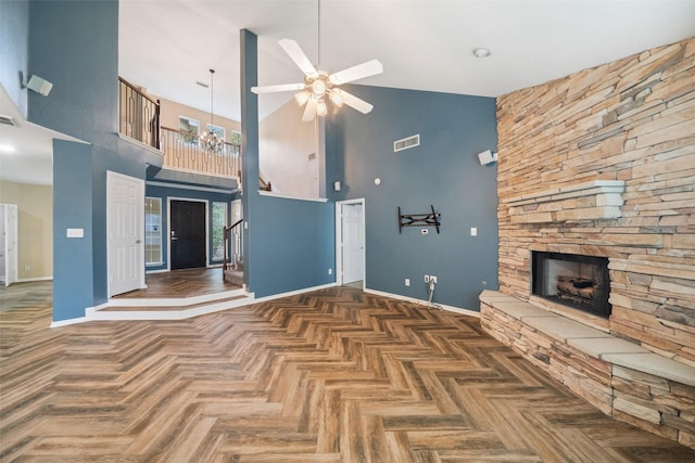 unfurnished living room with baseboards, visible vents, ceiling fan, stairs, and a stone fireplace