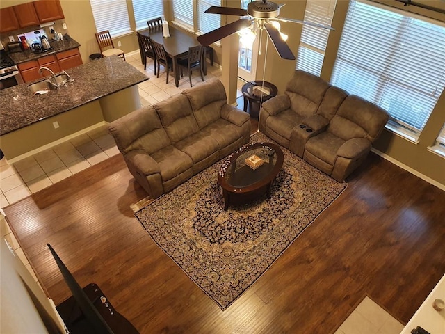 living room featuring a healthy amount of sunlight, baseboards, and wood finished floors