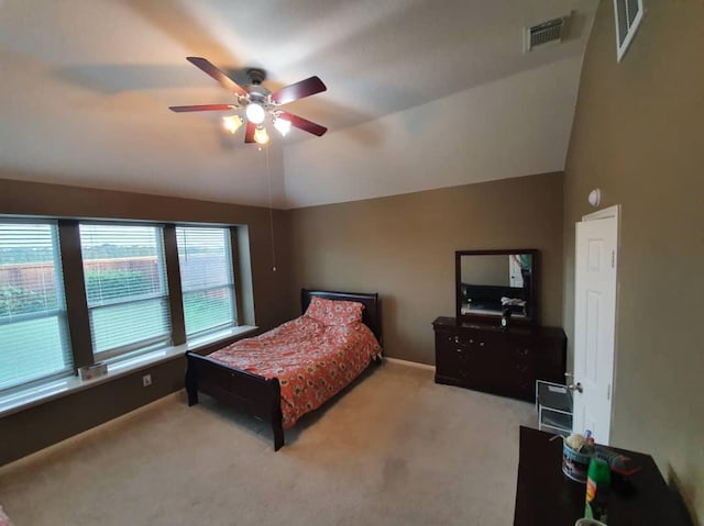 bedroom with lofted ceiling, visible vents, and carpet flooring