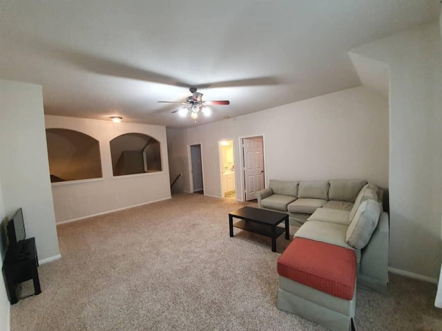 carpeted living room featuring ceiling fan and baseboards