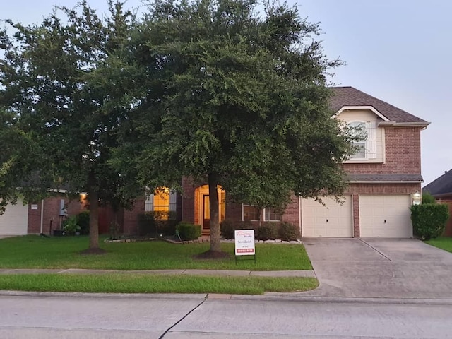 view of property hidden behind natural elements featuring a garage, a front yard, concrete driveway, and brick siding